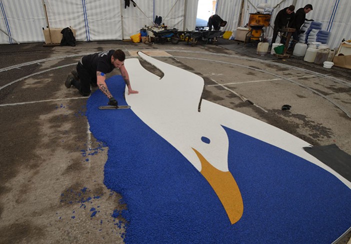 Clearstone installing resin bound Albion Seagull logo - Amex Community Stadium Brighton