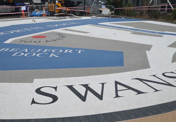 Resin bound colour way-finding dock side graphic, Parc Tawe retail park Swansea