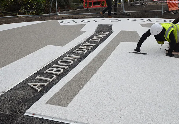 Resin bound colour way-finding dock side graphic, Parc Tawe retail park Swansea