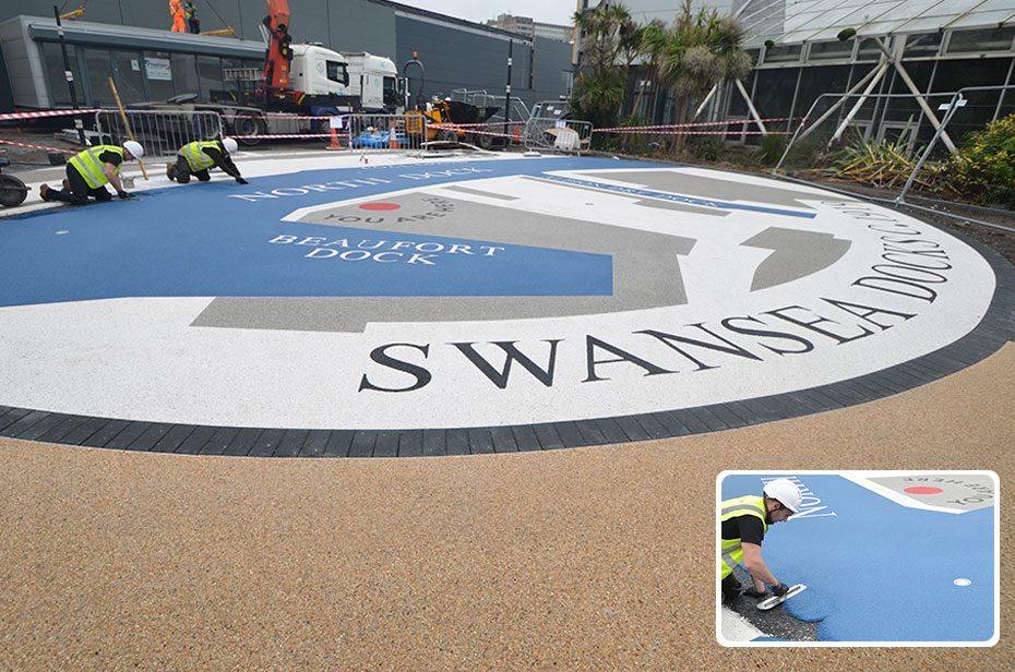 Resin bound wayfinding graphic for decorative landscaping paved forecourt at Parc Tawe Retail Park