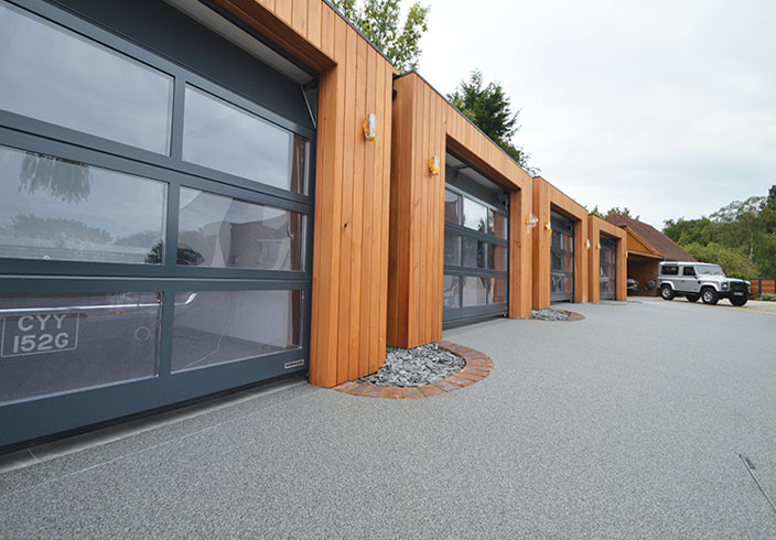 Resin bound drive for luxury garages A Room in My Garden Cuckfield, Sussex